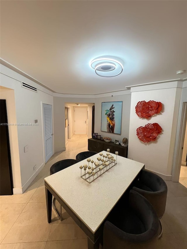 dining room with light tile patterned floors, visible vents, and baseboards