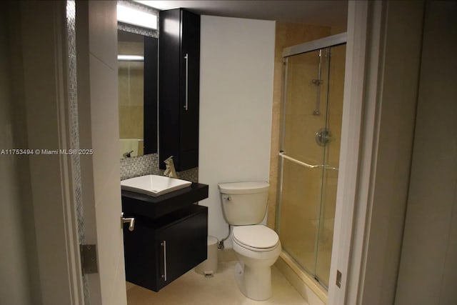 bathroom with toilet, a stall shower, tasteful backsplash, and vanity