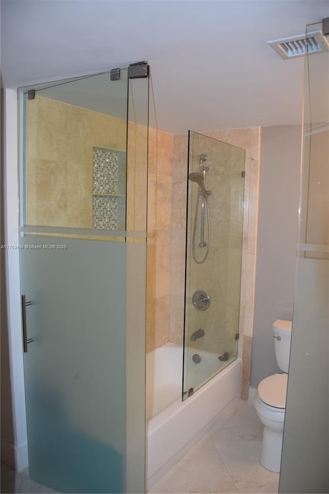 full bath with toilet, visible vents, and bath / shower combo with glass door