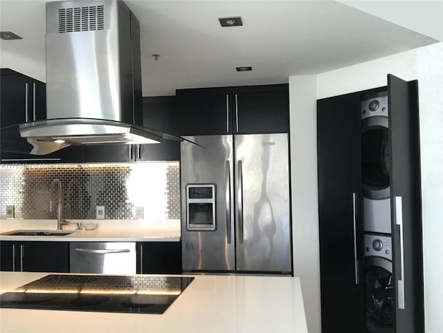 kitchen with island range hood, appliances with stainless steel finishes, and dark cabinetry