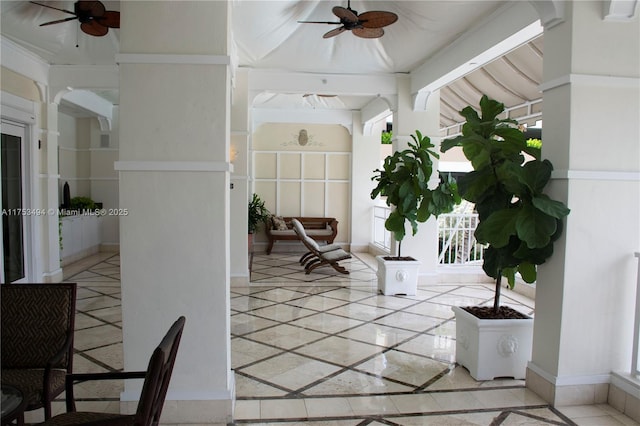 sunroom featuring ceiling fan