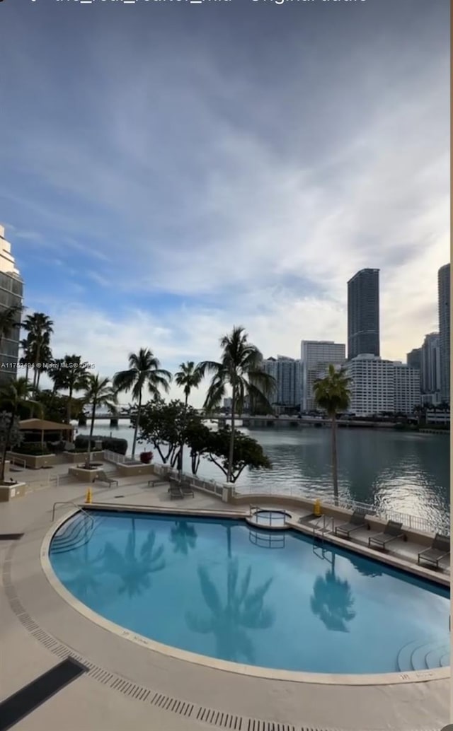 community pool with a view of city and a water view