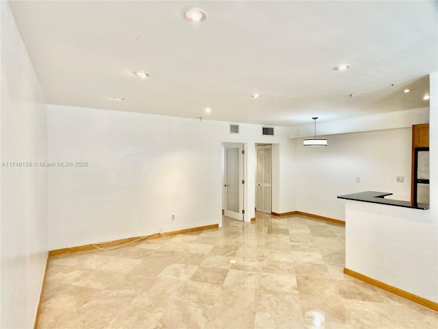 unfurnished room featuring recessed lighting, visible vents, and baseboards