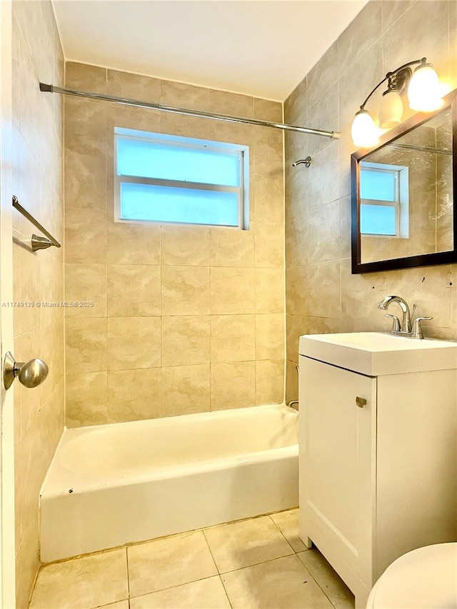 bathroom featuring shower / washtub combination, tile walls, toilet, vanity, and tile patterned flooring