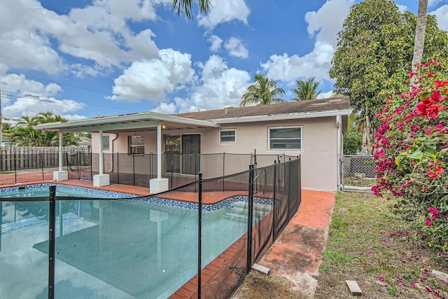 view of pool with a sunroom, fence, and a fenced in pool