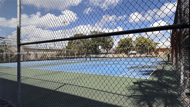 view of sport court featuring fence