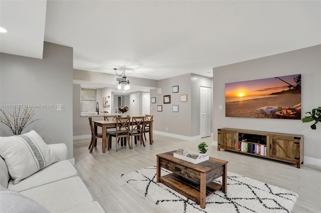 living area featuring light wood-type flooring and baseboards