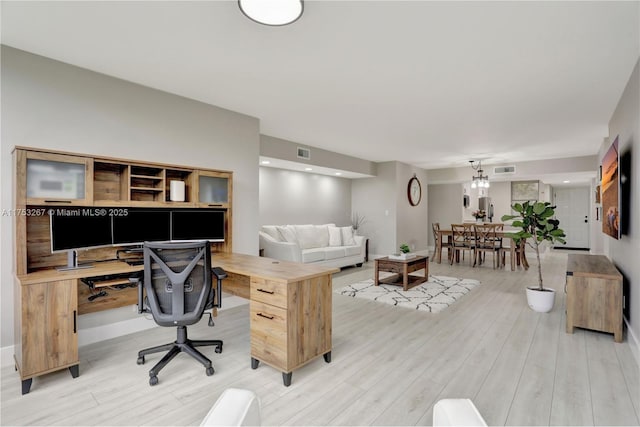 office featuring light wood-type flooring and visible vents