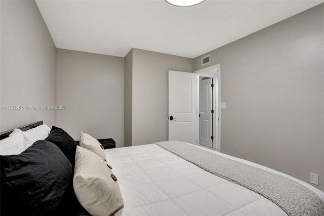 carpeted bedroom with baseboards and visible vents