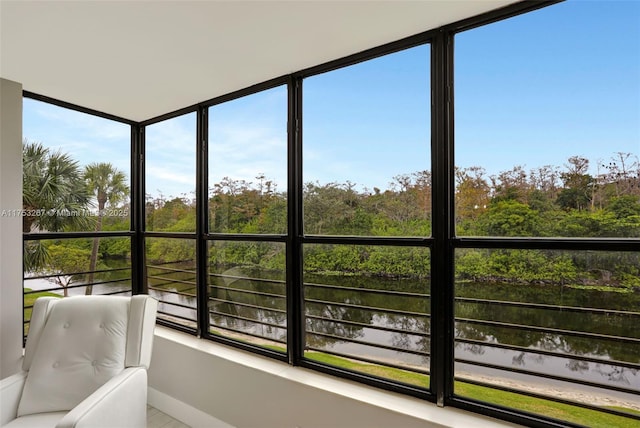 sunroom / solarium with a water view