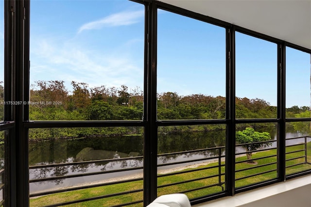 unfurnished sunroom featuring a water view