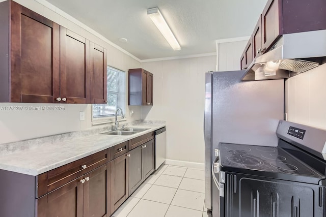 kitchen with light tile patterned floors, under cabinet range hood, a sink, light countertops, and appliances with stainless steel finishes