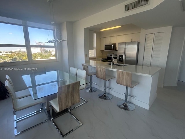 dining room with marble finish floor and visible vents