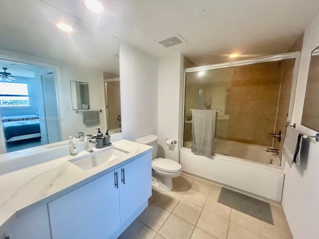 ensuite bathroom featuring visible vents, toilet, tile patterned flooring, combined bath / shower with glass door, and vanity