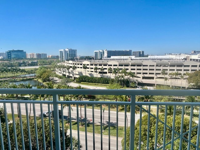 balcony featuring a view of city and a water view