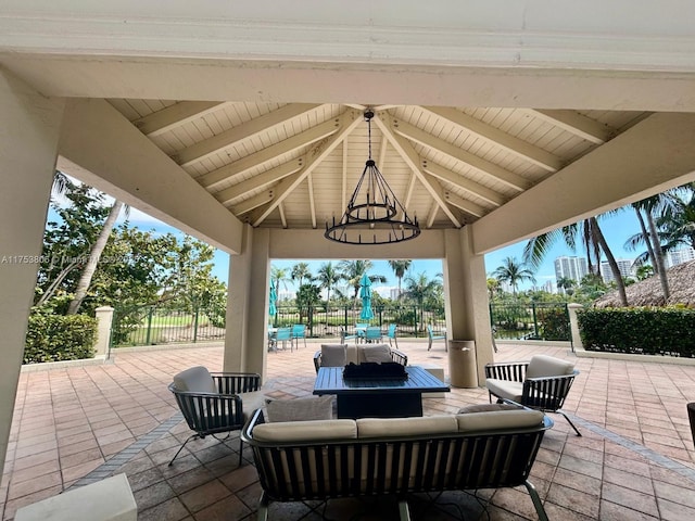 view of patio with a gazebo, outdoor lounge area, and fence