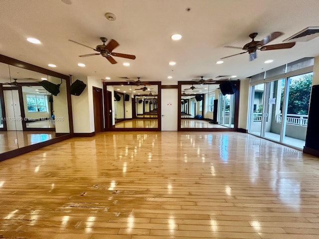 interior space with baseboards, visible vents, a ceiling fan, hardwood / wood-style floors, and recessed lighting