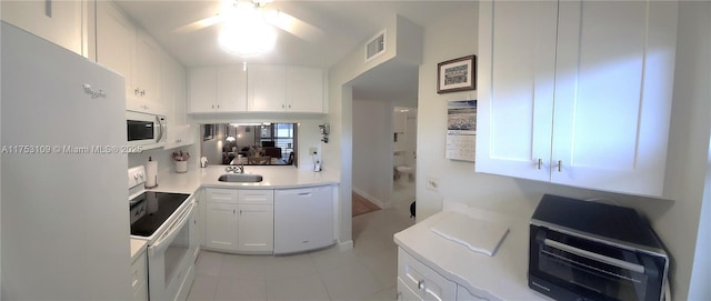 kitchen featuring visible vents, a sink, white cabinetry, white appliances, and light countertops