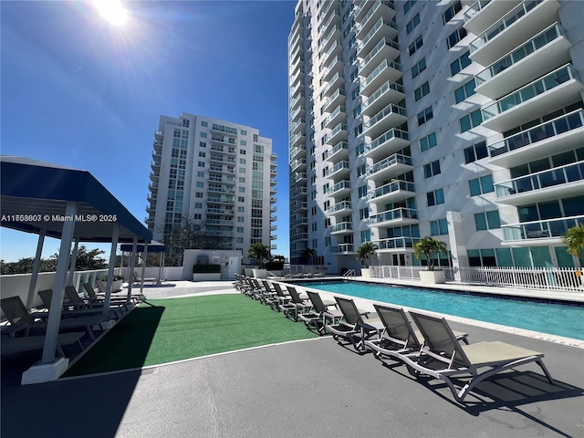 pool featuring a patio area and fence