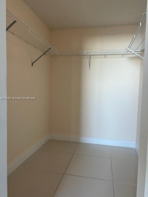 spacious closet with tile patterned floors