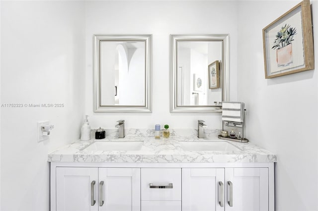 full bathroom with double vanity and a sink