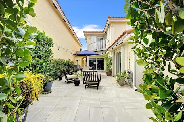 view of patio featuring a balcony