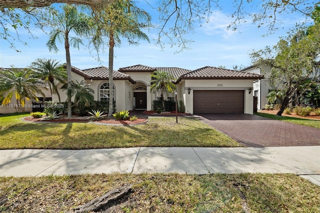 16358 S Mariposa Cir S, Pembroke Pines, FL 33331 - mediterranean / spanish-style house featuring a garage, a tile roof, stucco siding, a front lawn, and decorative driveway