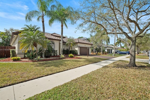 view of front of house with a tile roof, stucco siding, an attached garage, driveway, and a front lawn