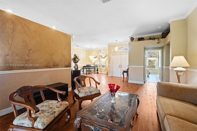 16358 S Mariposa Cir S, Pembroke Pines, FL 33331 - living area featuring visible vents, baseboards, crown molding, wood finished floors, and wallpapered walls