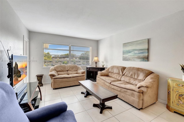 living room featuring light tile patterned flooring and baseboards