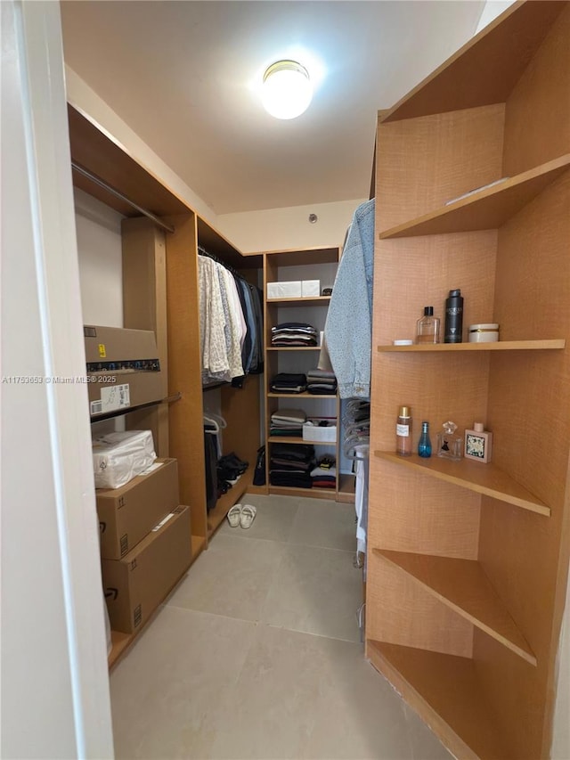 spacious closet with light tile patterned floors