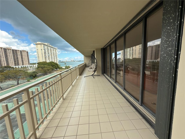 balcony featuring a view of city and a water view