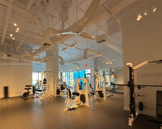 gym featuring a high ceiling and visible vents