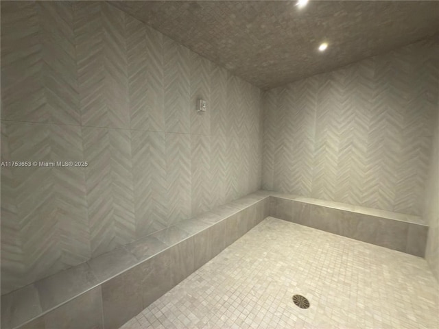 bathroom with recessed lighting and a tile shower