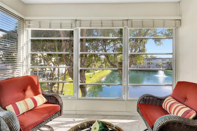 sunroom / solarium featuring a water view and a healthy amount of sunlight