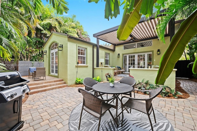 view of patio / terrace with french doors, outdoor dining area, grilling area, and fence