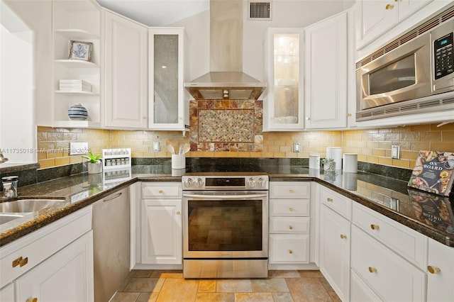 1109 NE 3rd St, Fort Lauderdale, FL 33301 - kitchen featuring wall chimney range hood, visible vents, decorative backsplash, and appliances with stainless steel finishes