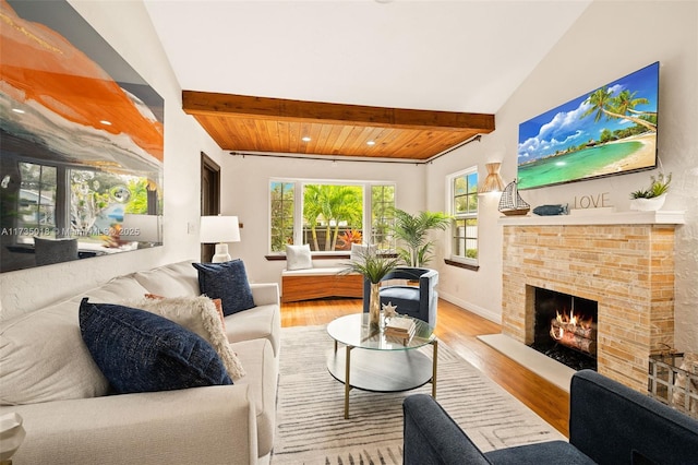 1109 NE 3rd St, Fort Lauderdale, FL 33301 - living area with baseboards, a fireplace, wood finished floors, and vaulted ceiling with beams