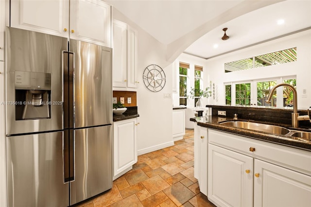 1109 NE 3rd St, Fort Lauderdale, FL 33301 - kitchen featuring stainless steel fridge with ice dispenser, white cabinetry, arched walkways, and a sink