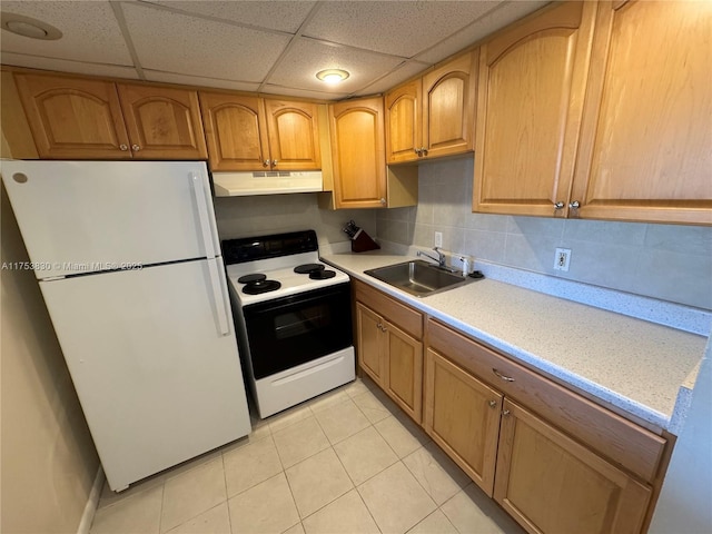 kitchen featuring under cabinet range hood, white appliances, a sink, light countertops, and decorative backsplash