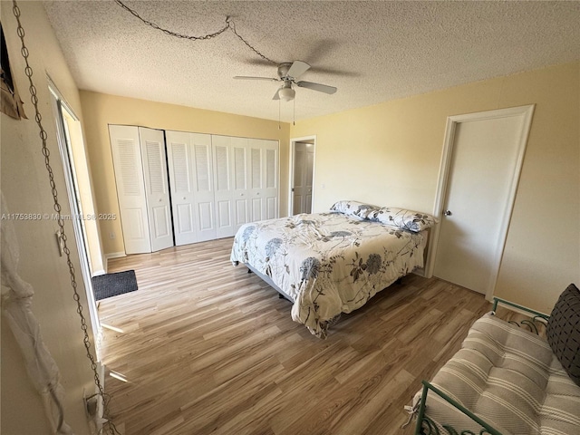 bedroom featuring a textured ceiling, ceiling fan, a closet, and wood finished floors