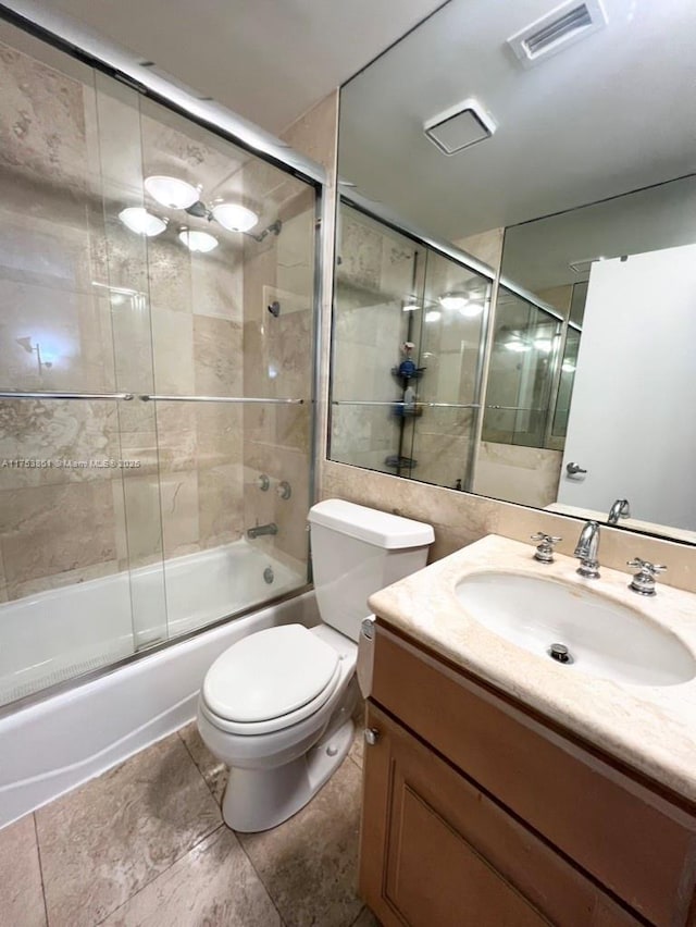 full bathroom featuring enclosed tub / shower combo, toilet, vanity, and visible vents