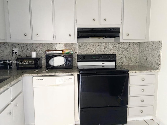 kitchen featuring tasteful backsplash, white cabinets, light stone counters, under cabinet range hood, and black appliances