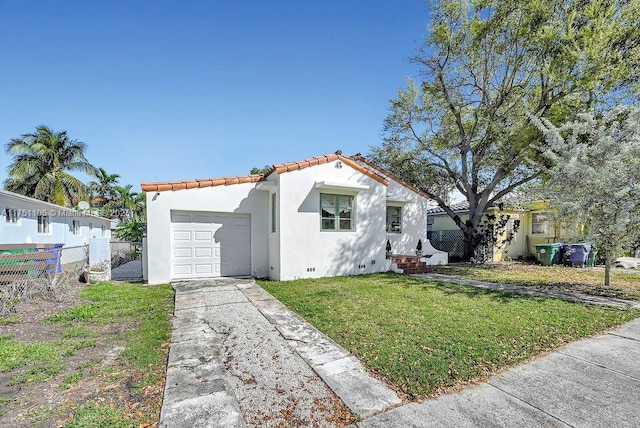 mediterranean / spanish-style house featuring a garage, fence, concrete driveway, crawl space, and stucco siding