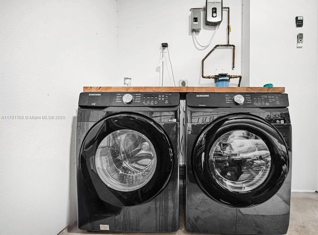 washroom featuring laundry area and separate washer and dryer