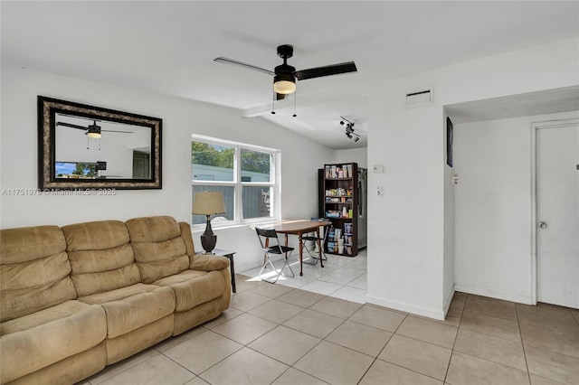 living room featuring lofted ceiling, visible vents, ceiling fan, and light tile patterned flooring