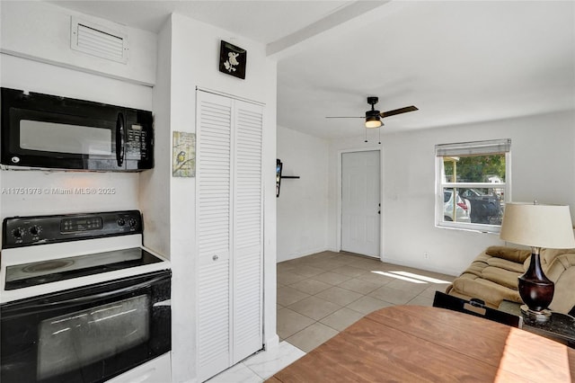 kitchen featuring baseboards, a ceiling fan, electric stove, tile patterned flooring, and black microwave