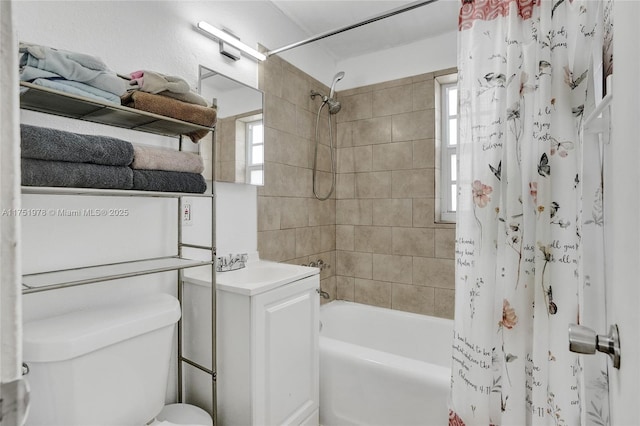 bathroom with toilet, shower / bathtub combination with curtain, and vanity