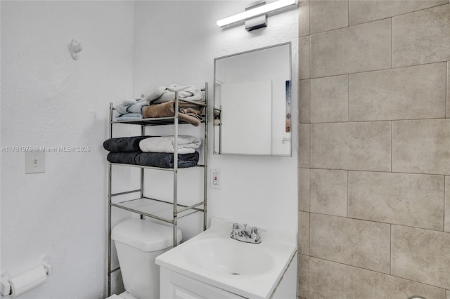 bathroom featuring toilet and vanity