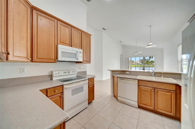 kitchen with lofted ceiling, light countertops, light tile patterned flooring, a sink, and white appliances